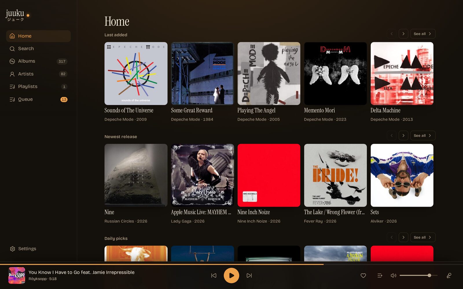 The library on a wide screen: shelves of last played, last added and newest release albums, player docked at the bottom.